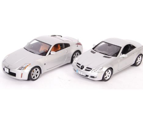 Two 1/18 scale diecast models comprising: Paul's Model Art Minichamps Mercedes Benz SLK Class 2004 and an Autoart Nissan 350Z