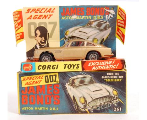 An original vintage Corgi Toys diecast model No. 261 ' James Bond 007 Aston Martin DB5 .' In gold, with silver spoked wheels.