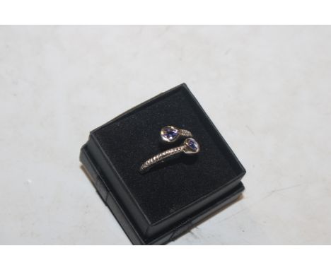 A Sterling silver and tanzanite cross over ring, ring size L/M