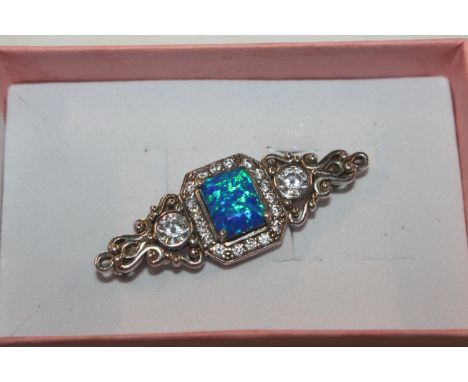 A vintage Sterling silver brooch set with cubic zirconia and opal