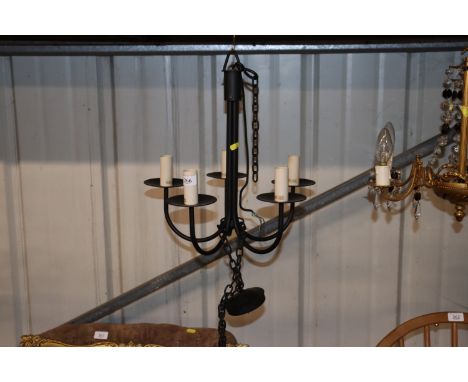 A wrought metal five light chandelier 