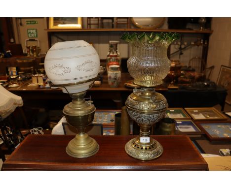 A brass table lamp with green tinted glass frilled shade and another 
