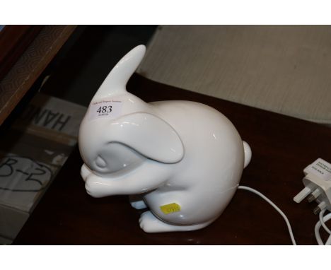 A white glazed porcelain rabbit table lamp