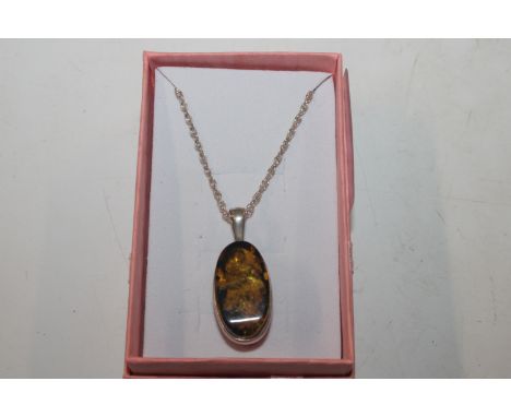 A vintage Sterling silver and amber double sided pendant 