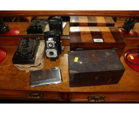 A Victorian inlaid tea caddy; a mahogany tea caddy; a Comet Popular 12 camera lens; a Rajar No.6 camera and a novelty cigaret