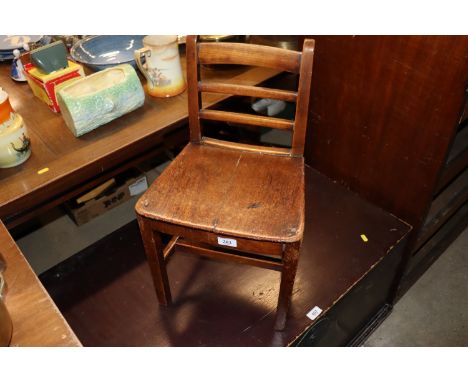 A 19th Century elm seated ladder back child's chair 
