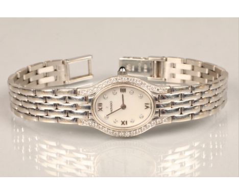 Ladies 14K white gold Movado wrist watch, mother of pearl dial with sapphire crystal hour markers and bezel on a 14K white go