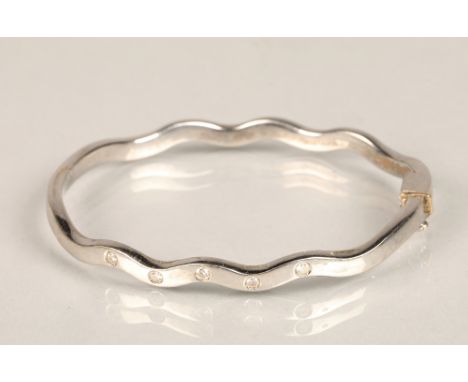 Ladies 18ct white gold stiff bangle, set with five small diamonds, weight 27g 