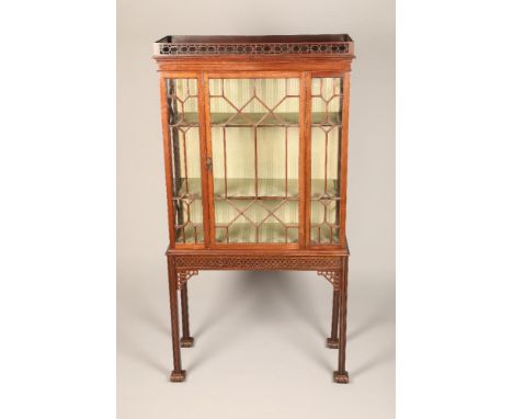 Chippendale style mahogany display cabinet, fretwork gallery over an astragal glass cabinet with single door, shelved interio