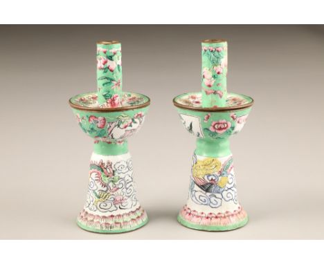 Pair of Chinese canton enamel candlesticks, apple green and white enamelled ground decorated with dragons amongst clouds with