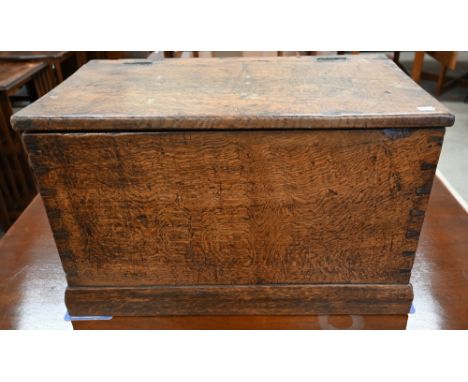 An antique dove-tailed elm trunk with hinged top and flush brass campaign style handles, 66 x 36 x 40 cm high 