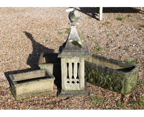 A reconstituted weathered stone Portuguese chimney pot, 90 cm high, two cast stone trough planters and terracotta square plan