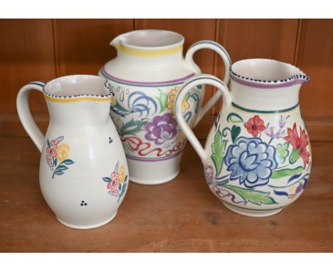 Three Poole Pottery floral-painted jugs, 21.5 - 18 cm (3 - largest chipped under foot) 