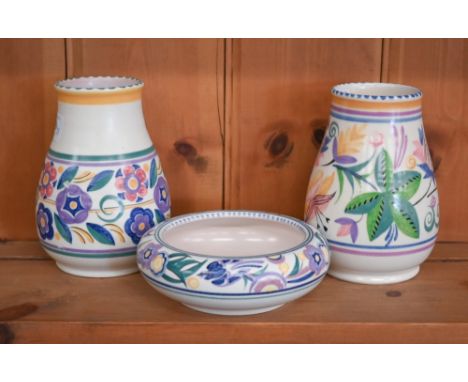 Two Poole pottery vases with stylized floral-painted decoration, 15 cm, to/w a 14.5 cm diameter shallow bowl with similar dec