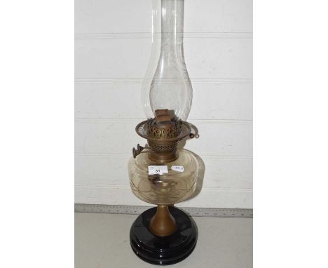 A vintage oil lamp with glass font