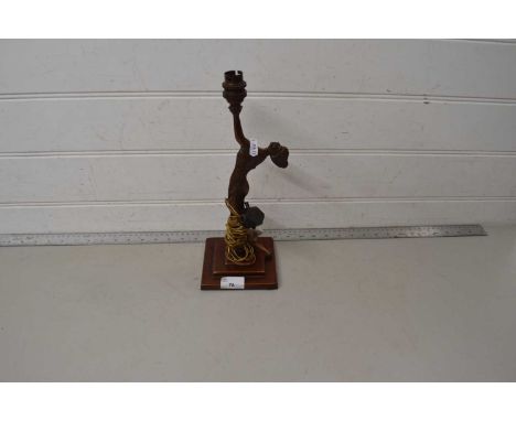 A Art Deco style figural table lamp on a metal table lamp base