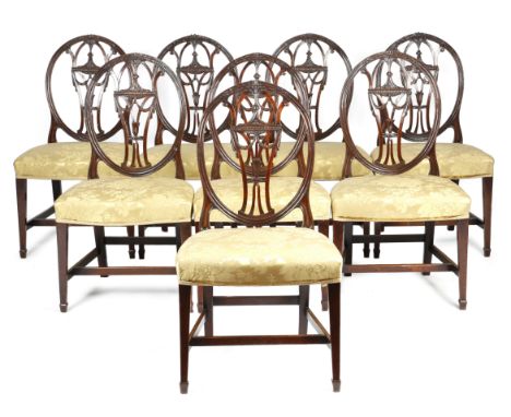 A set of eight George III mahogany 'Hepplewhite' dining chairs, each with an oval back with a pierced splat carved with leave