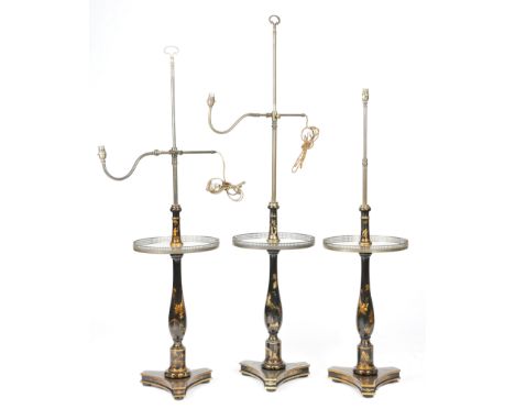 Three japanned black lacquer lamp tables, with brass fittings and decorated with gilt highlights with chinoiserie scenes and 