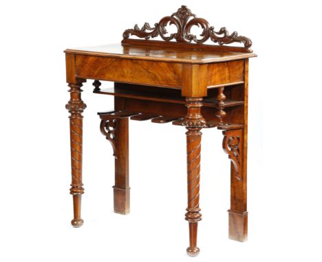 An unusual Victorian walnut whip and boot hall table, with a leaf and flower carved top rail above a shelf and with divisions