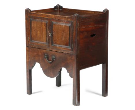 A George III mahogany tray-top bedside commode, with a pair of fielded panel doors, above a converted leather lined pull-out 