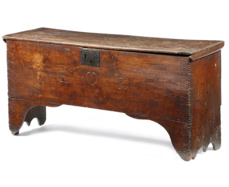 An elm coffer, the hinged top with a moulded edge, revealing a lidded till, the front with crimped edges and incised zigzag d