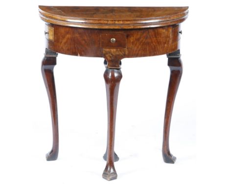 A small George II walnut demi-lune card table, the hinged fold-over top with a moulded edge and cross and feather banding, re