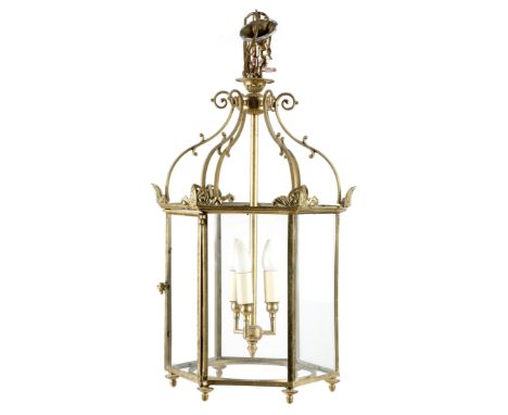 A gilt brass hexagonal hall lantern in Regency style, with a three-light fitting with six glass panels, one with a hinged doo