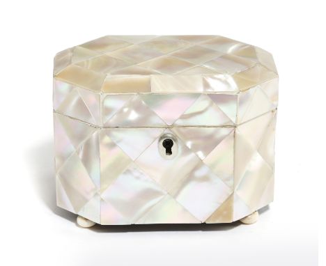 λ A small Victorian mother of pearl tea caddy, of canted form, the hinged lid revealing a lidded interior, with ivory edging,