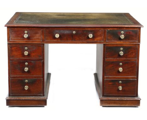 A George IV mahogany twin pedestal partner's desk, the moulded edge top inset with green tooled leather, above an arrangement