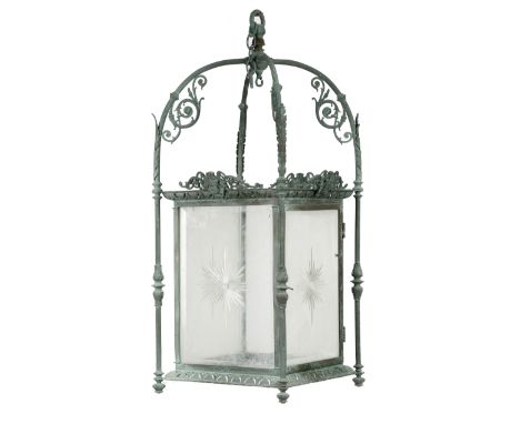 A late Victorian bronze hall lantern, with a verdigris finish, with reeded supports applied with leaves and scrolls, with pie