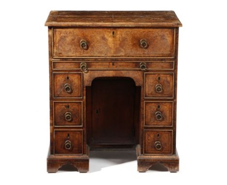 A George II walnut and burr walnut secretaire kneehole desk, the quarter veneered top with cross and feather banding and with