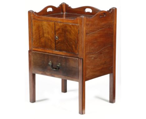A George III mahogany tray-top bedside commode, the serpentine gallery pierced with three handgrips, above a pair of cupboard
