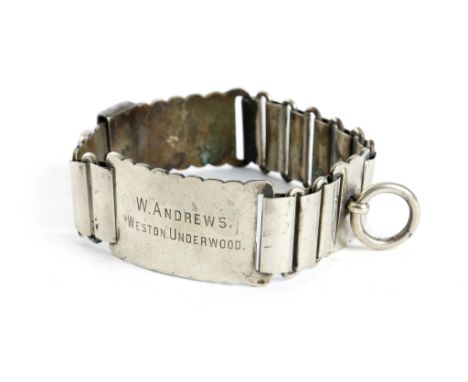 A Victorian nickel dog collar, of chain form, with a lock and key, inscribed 'W. ANDREWS WESTON UNDERWOOD', 12cm diameter.