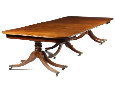 λ A George III and later mahogany triple pillar dining table, the reeded edge top with later rosewood and parquetry crossband