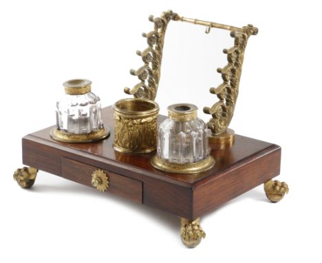 λ A 19th century rosewood and gilt brass mounted inkstand, the raised back with a watch and pen holder, above three cylindric