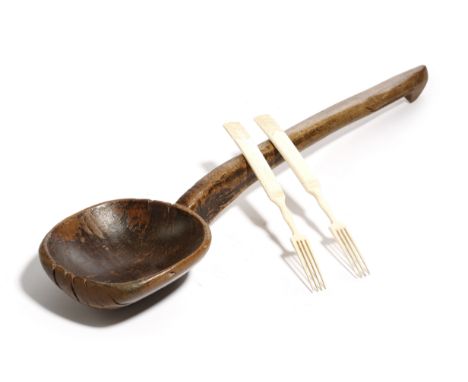 A 19th century treen wooden ladle, together with a pair of prisoner of war bone forks, 42cm (max). (3)