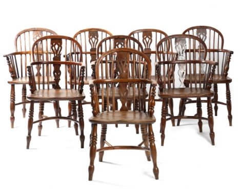 A matched set of eight Victorian yew lowback Windsor armchairs, each with a stick back with a pierced splat, above an elm sea