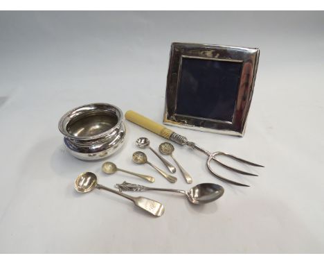 A quantity of silver and white metal items to include toasting fork, white metal photo frame, silver bowl and teaspoons etc.