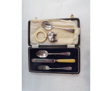 A cased silver Christening set, one silver plated replacement knife together with a silver fork/spoon and a silver rattle tee
