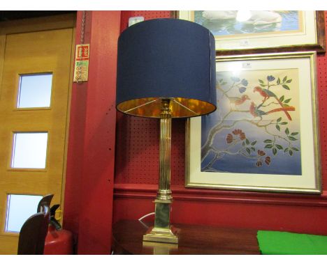 A modern brass column form table lamp base on stepped base with blue shade 