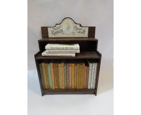 A small bookcase labelled "Peter Rabbit's Book-Shelf" with 25 Beatrix Potter books