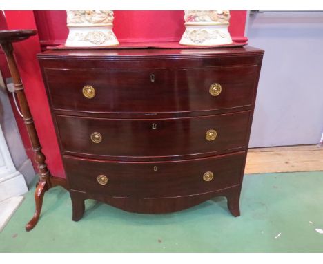 A circa 1830 flame mahogany bow-front chest of three graduating long drawers with oak linings over outswept bracket feet havi