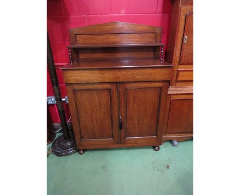 A Regency mahogany side cabinet the raised shelf back over a single drawer and two door cupboard on turned feet with working 