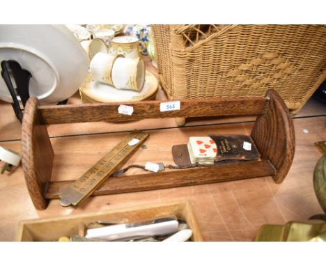 A set of vintage playing cards, a fold out ruler and an oak book trough or shelf