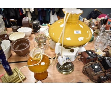 A mid century amber glass mushroom style light and an oil lamp with bird themed well