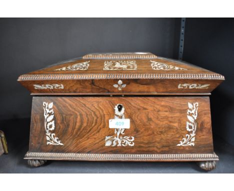 A 19th century rose wood tea caddy of sarcophagus form with mother of pearl inlay and fitted interior
