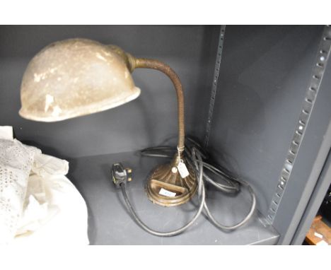 A desk top adjustable machinists or engineers lamp having an art deco design and metal shade.