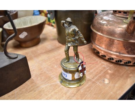A small bronzed figure of a life boat man approx 10cm tall and a similar enamel badge