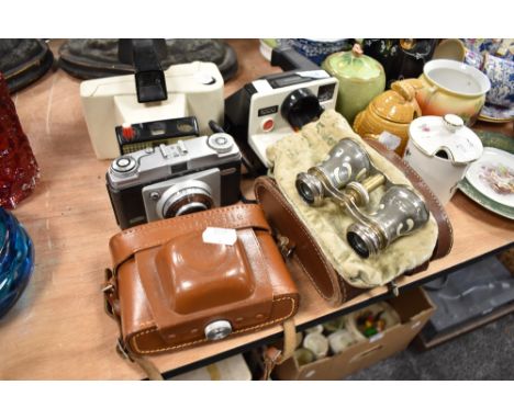 Two Polaroid cameras, a Dacora dignette and a pair of decorated opera glasses