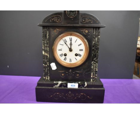 An antique marble mantel clock having roman numerals to enamel face and engraved detailing to surround.